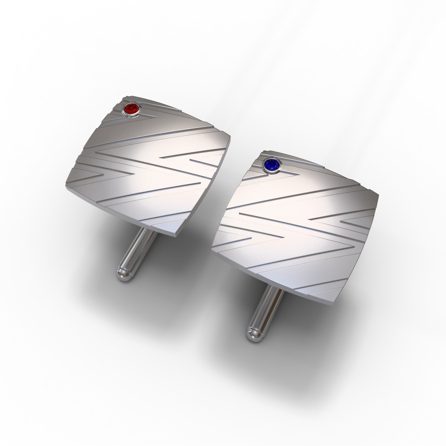 Bandor Essence Cufflinks in platinum, the pair seen three-quarter, bolt pattern with flush-set ruby and sapphire