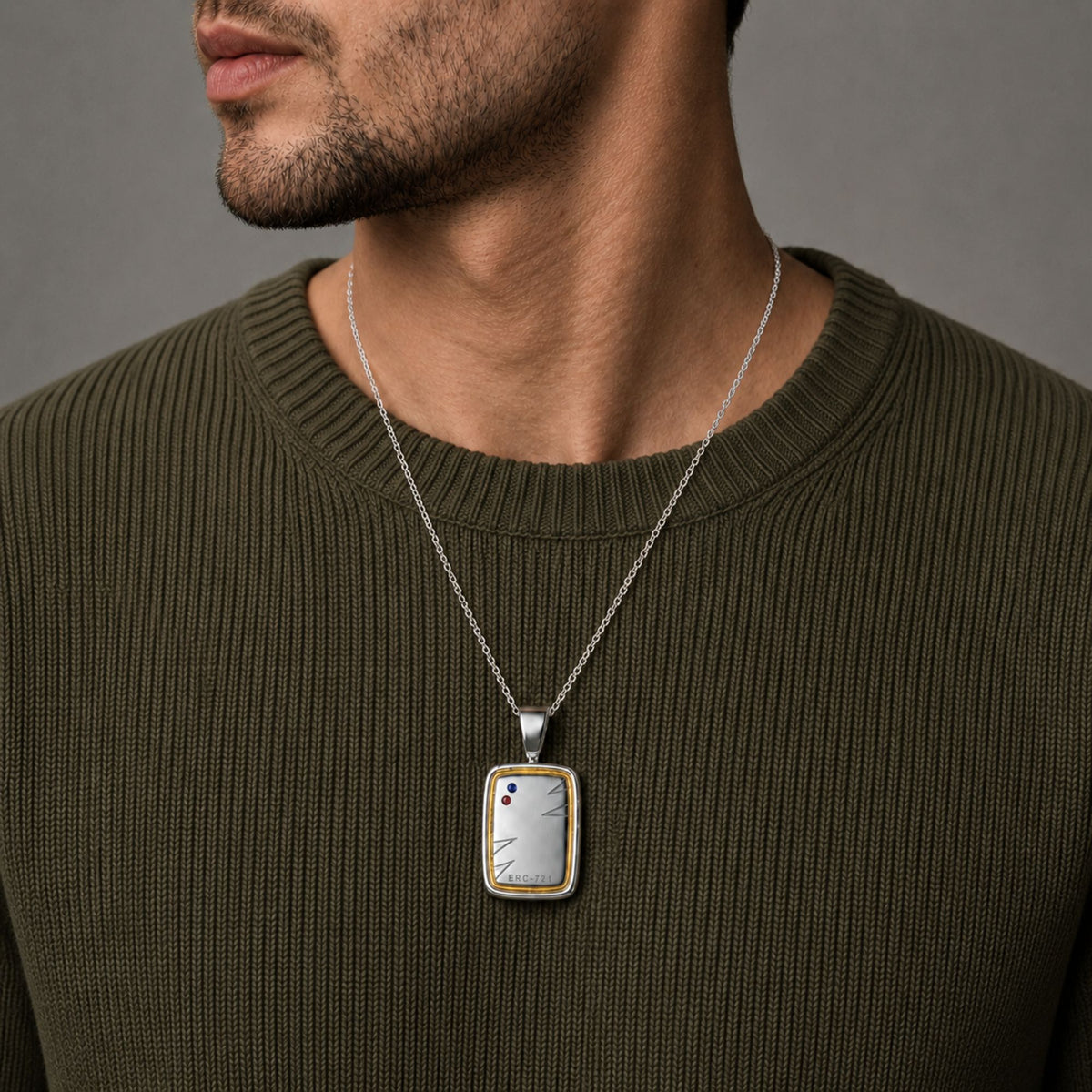 Man in an olive knit wearing the Bandor Essence Pendant on a platinum chain