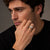 Man wearing the Bandor Essence Ring in platinum and 18k gold, hand resting against his jaw