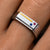Close-up of the Bandor Essence Ring on the finger: 18k gold inlay with flush-set ruby and sapphire