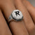 Close-up of the Bandor Signet Ring on the finger: octagonal solid platinum face, bolt seal, natural black diamond halo and 7423 engraving. Luxury men's platinum signet ring.